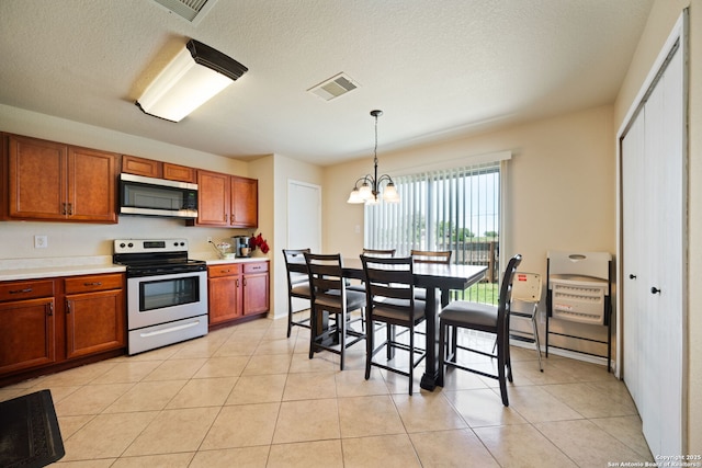 623 Cherokee, New Braunfels, TX 78132 - kitchen featuring appliances with stainless steel finishes, a chandelier, brown cabinets, light countertops, and a textured ceiling