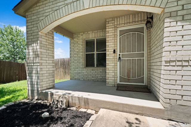 623 Cherokee, New Braunfels, TX 78132 - property entrance with fence, brick siding, and covered porch