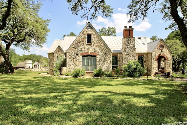 10020 Autumn Wood, Spring Branch, TX 78070 - tudor house featuring a standing seam roof, a chimney, a front lawn, and stone siding