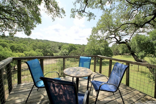 10020 Autumn Wood, Spring Branch, TX 78070 - wooden deck with a view of trees and outdoor dining space