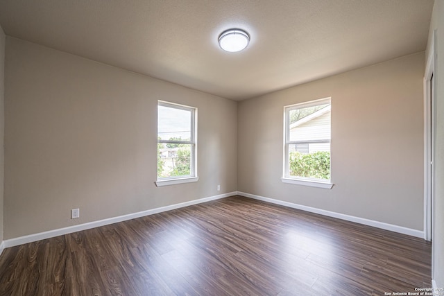 4915 Clark, San Antonio, TX 78223 - empty room with dark wood-style flooring, healthy amount of natural light, and baseboards