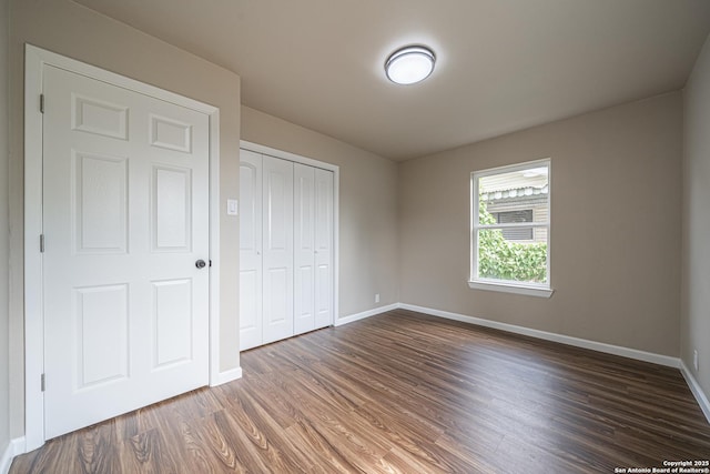 4915 Clark, San Antonio, TX 78223 - unfurnished bedroom featuring baseboards, wood finished floors, and a closet