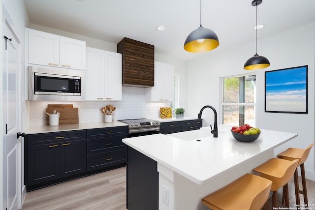 580 Compass Rose, Canyon Lake, TX 78133 - kitchen featuring stainless steel appliances, a sink, light wood finished floors, decorative backsplash, and recessed lighting