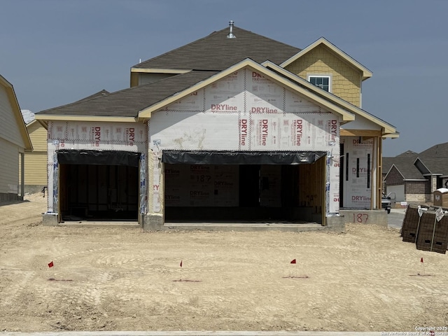 187 Hunters Cp, San Antonio, TX 78245 - unfinished property featuring driveway, a shingled roof, and an attached garage