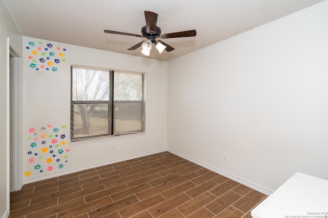 8013 County Road 128, Floresville, TX 78114 - spare room with ceiling fan, dark wood-style flooring, baseboards, and a textured ceiling