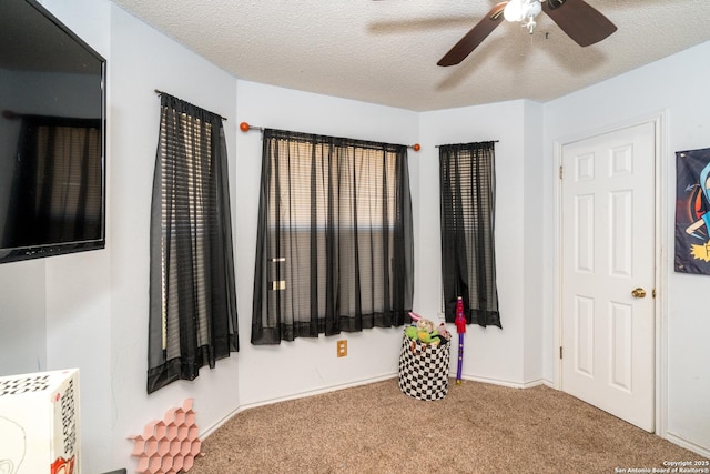8013 County Road 128, Floresville, TX 78114 - carpeted bedroom with a textured ceiling and ceiling fan