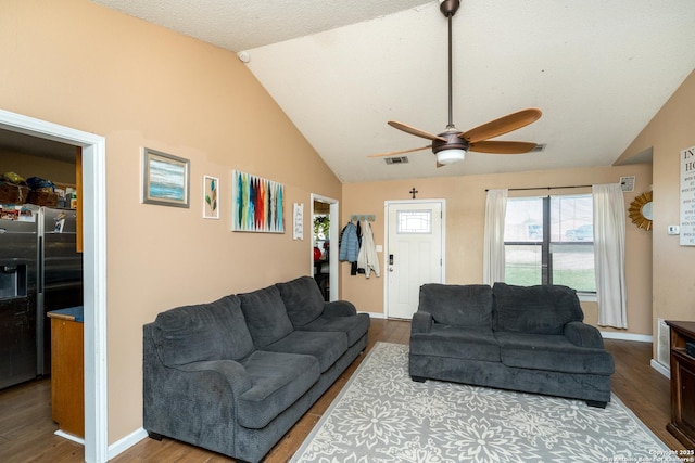 8013 County Road 128, Floresville, TX 78114 - living area with vaulted ceiling, a ceiling fan, wood finished floors, and baseboards