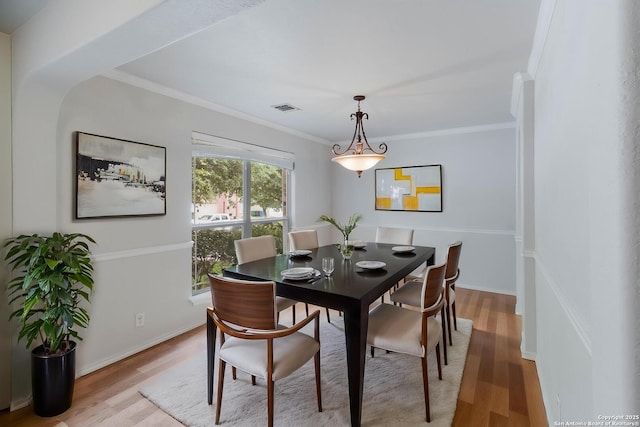7326 Concerto Dr, San Antonio, TX 78266 - dining space with light wood-type flooring, crown molding, and baseboards