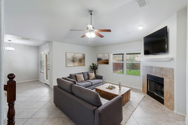 7326 Concerto Dr, San Antonio, TX 78266 - living room featuring a fireplace, a ceiling fan, light tile patterned flooring, and baseboards