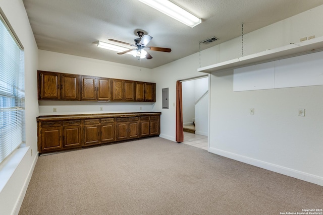 1588 Winding Crk, Spring Branch, TX 78070 - kitchen with electric panel, light colored carpet, a ceiling fan, and baseboards