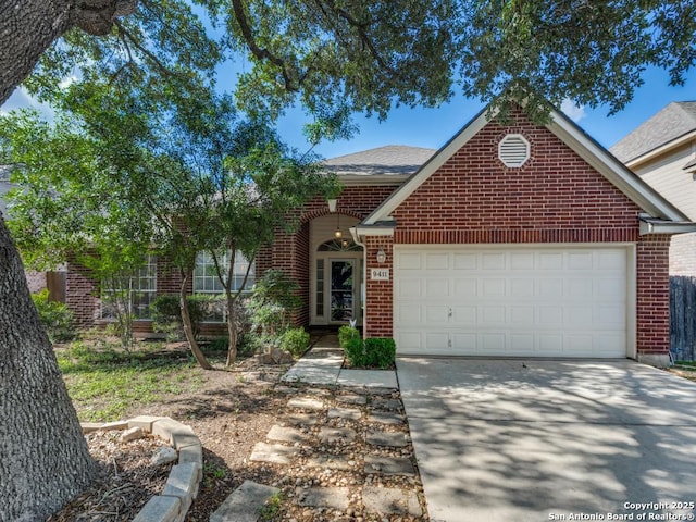 9411 Camino Venado, Helotes, TX 78023 - view of front facade featuring brick siding, a garage, concrete driveway, and a shingled roof