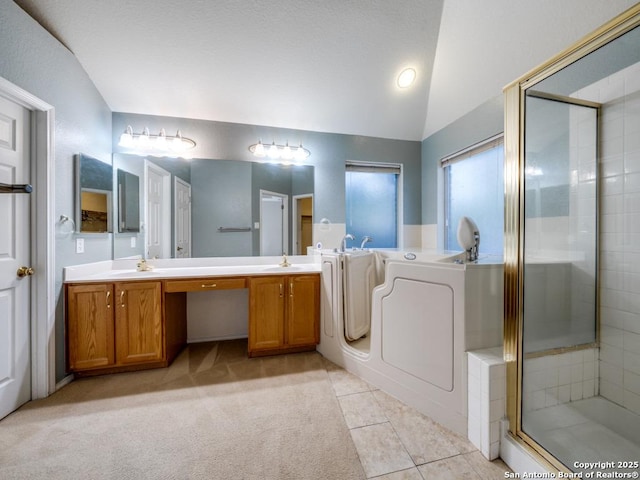 9411 Camino Venado, Helotes, TX 78023 - full bathroom with vaulted ceiling, a shower stall, a garden tub, washer / dryer, and double vanity
