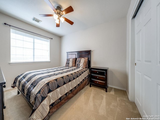 9411 Camino Venado, Helotes, TX 78023 - bedroom featuring light colored carpet, baseboards, a closet, and a ceiling fan