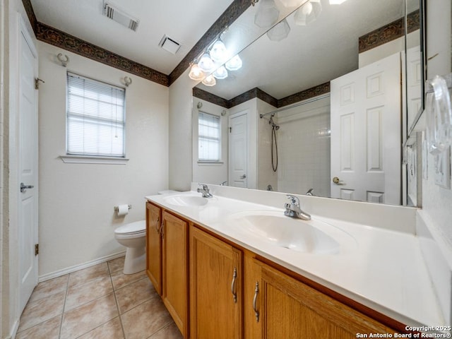 9411 Camino Venado, Helotes, TX 78023 - full bathroom featuring a shower, toilet, double vanity, and tile patterned floors