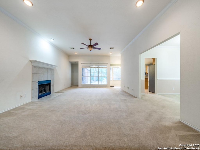 9411 Camino Venado, Helotes, TX 78023 - unfurnished living room with ornamental molding, a ceiling fan, light colored carpet, a fireplace, and recessed lighting