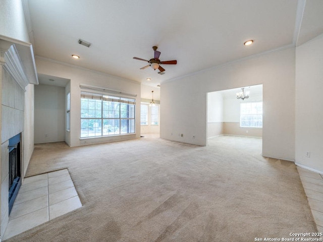 9411 Camino Venado, Helotes, TX 78023 - unfurnished living room featuring a chandelier, a tile fireplace, carpet flooring, ornamental molding, and a ceiling fan