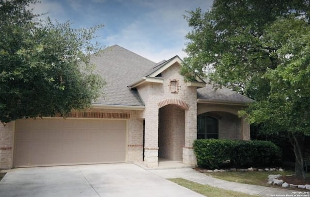 3526 Arroyo Grande, San Antonio, TX 78253 - view of front of house featuring brick siding, roof with shingles, and concrete driveway