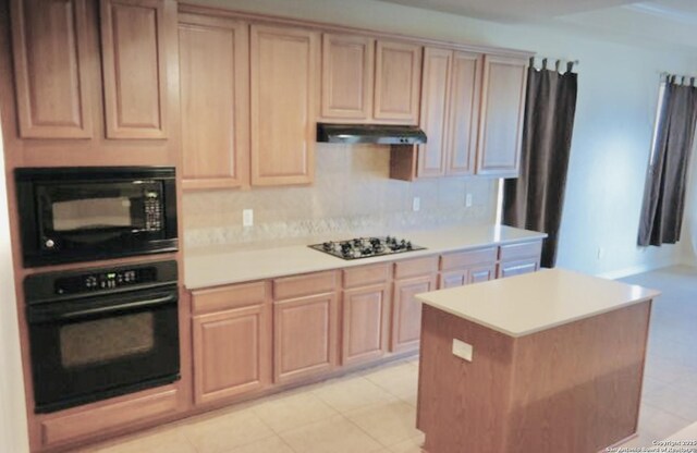 3526 Arroyo Grande, San Antonio, TX 78253 - kitchen featuring black appliances, under cabinet range hood, light countertops, light brown cabinets, and backsplash