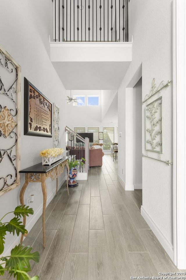 63 Ricadonna, San Antonio, TX 78253 - corridor featuring a towering ceiling, baseboards, and wood finished floors