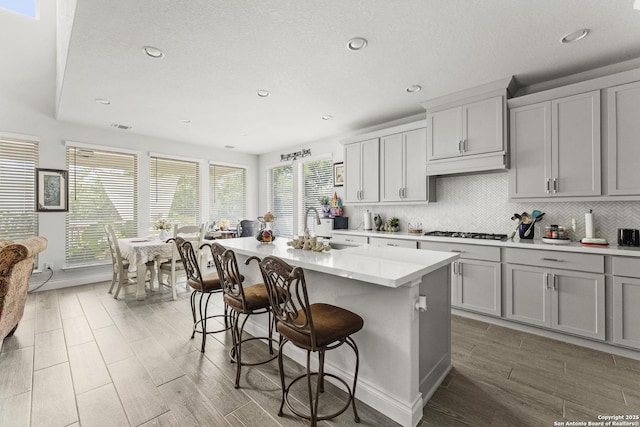 63 Ricadonna, San Antonio, TX 78253 - kitchen featuring a sink, stainless steel gas stovetop, recessed lighting, light countertops, and a breakfast bar area