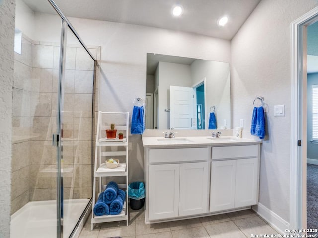 3075 Mondavi Crst, Schertz, TX 78154 - full bath featuring a shower stall, double vanity, baseboards, and tile patterned floors