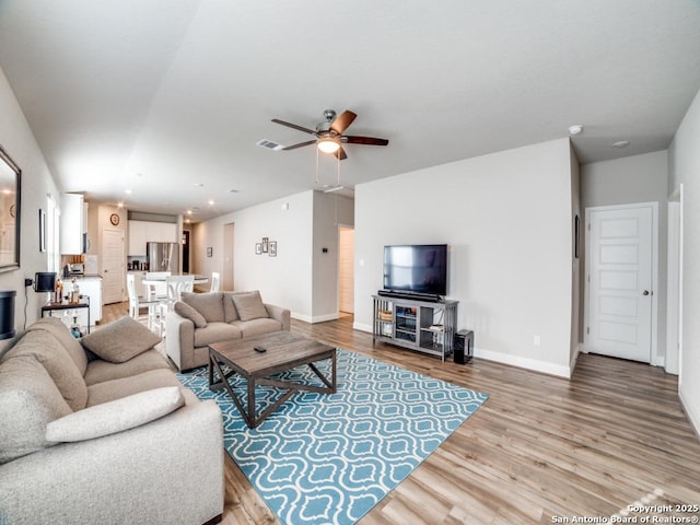 3075 Mondavi Crst, Schertz, TX 78154 - living room featuring wood finished floors, ceiling fan, baseboards, and recessed lighting