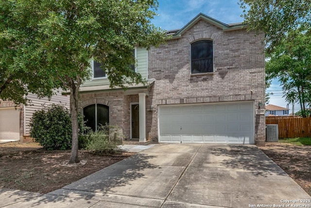 9011 Acorn Frst, San Antonio, TX 78251 - view of front of house featuring concrete driveway, an attached garage, fence, and central AC unit