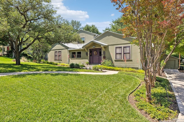 261 Fair Oaks, Alamo Heights, TX 78209 - view of front facade featuring stucco siding, a front yard, a garage, metal roof, and driveway
