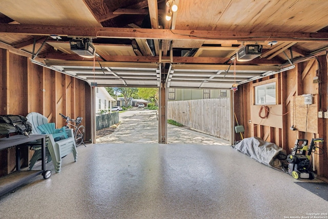 261 Fair Oaks, Alamo Heights, TX 78209 - garage featuring a garage door opener and wood walls