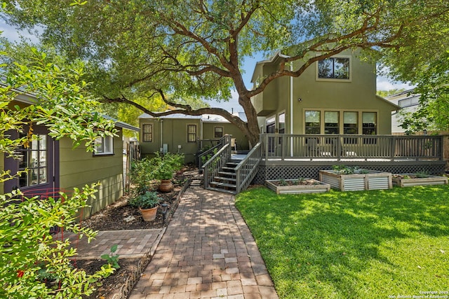 261 Fair Oaks, Alamo Heights, TX 78209 - back of property featuring a vegetable garden, a lawn, and a deck