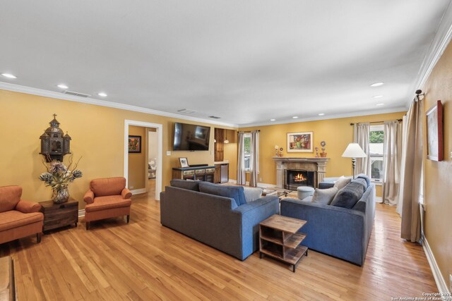 261 Fair Oaks, Alamo Heights, TX 78209 - living room featuring a lit fireplace, light wood-type flooring, recessed lighting, baseboards, and crown molding