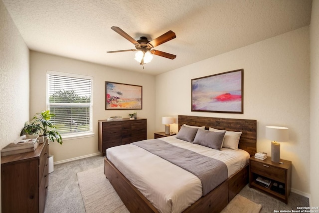 10438 Sun Ml, San Antonio, TX 78254 - bedroom featuring light carpet, baseboards, a ceiling fan, and a textured ceiling