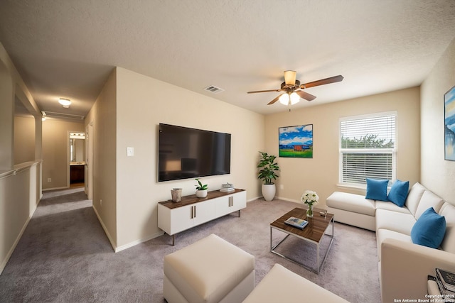 10438 Sun Ml, San Antonio, TX 78254 - carpeted living area featuring ceiling fan, baseboards, and a textured ceiling