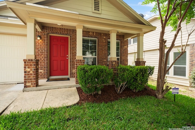 10438 Sun Ml, San Antonio, TX 78254 - property entrance with brick siding, a garage, covered porch, and driveway