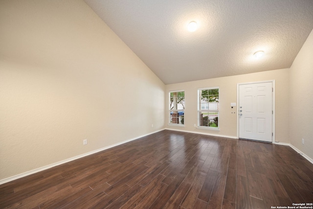10438 Sun Ml, San Antonio, TX 78254 - unfurnished living room with dark wood finished floors, vaulted ceiling, baseboards, and a textured ceiling