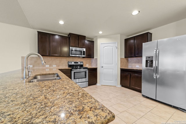 1407 Frio Eagle, San Antonio, TX 78245 - kitchen featuring stainless steel appliances, a sink, dark brown cabinetry, backsplash, and recessed lighting