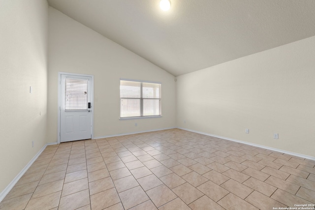 1407 Frio Eagle, San Antonio, TX 78245 - empty room with vaulted ceiling, baseboards, and light tile patterned flooring