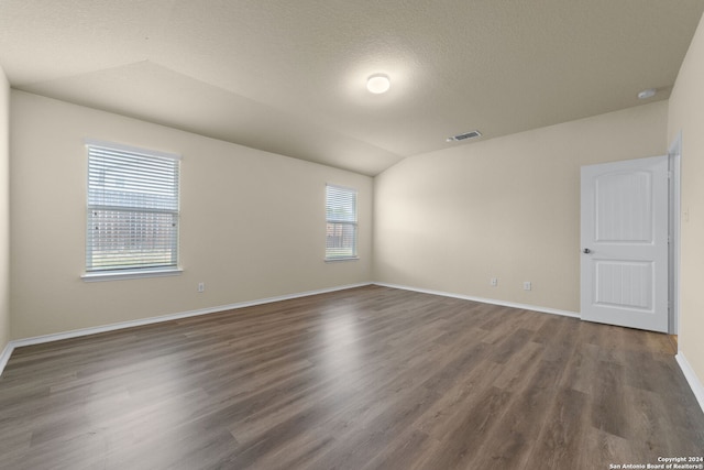 1407 Frio Eagle, San Antonio, TX 78245 - spare room featuring dark wood-style floors, baseboards, and lofted ceiling