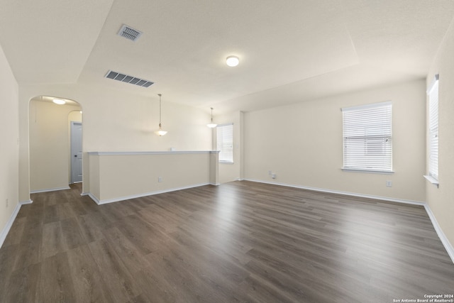 1407 Frio Eagle, San Antonio, TX 78245 - unfurnished room featuring arched walkways, dark wood-style floors, and baseboards