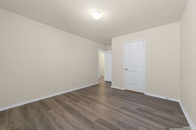 1407 Frio Eagle, San Antonio, TX 78245 - unfurnished bedroom with dark wood-style floors and baseboards