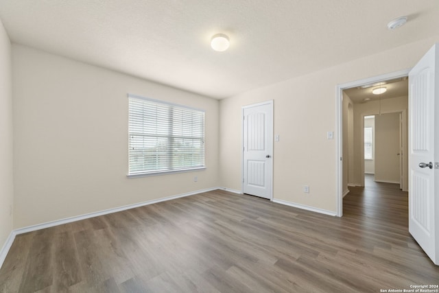 1407 Frio Eagle, San Antonio, TX 78245 - unfurnished bedroom featuring attic access, wood finished floors, and baseboards