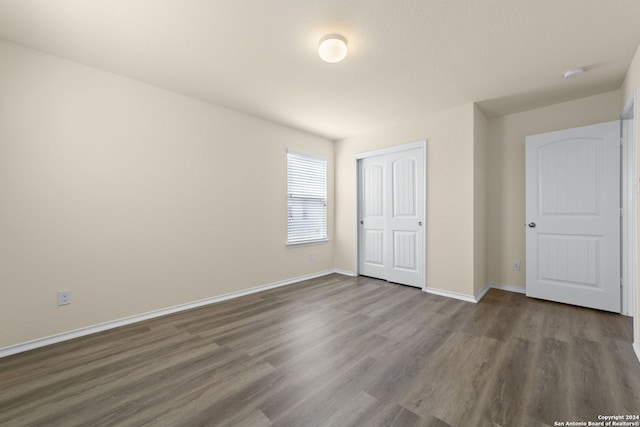1407 Frio Eagle, San Antonio, TX 78245 - unfurnished bedroom with wood finished floors, baseboards, and a closet