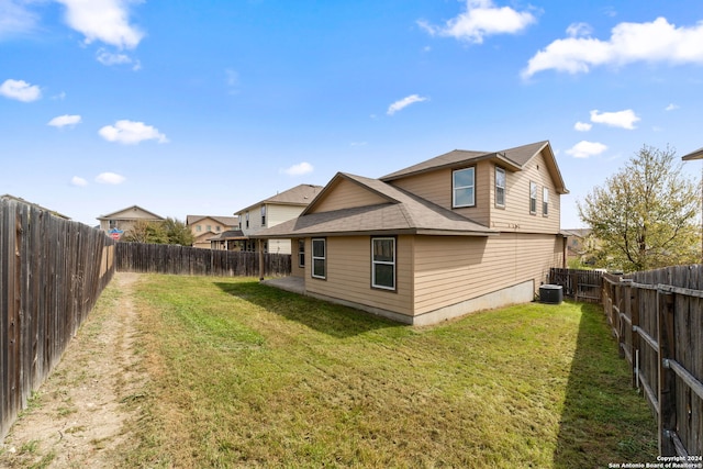 1407 Frio Eagle, San Antonio, TX 78245 - rear view of house with central air condition unit and roof with shingles