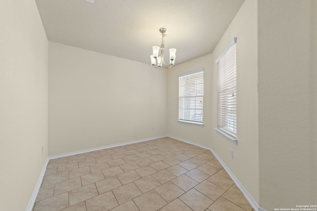 1407 Frio Eagle, San Antonio, TX 78245 - empty room featuring a chandelier, baseboards, and light tile patterned floors