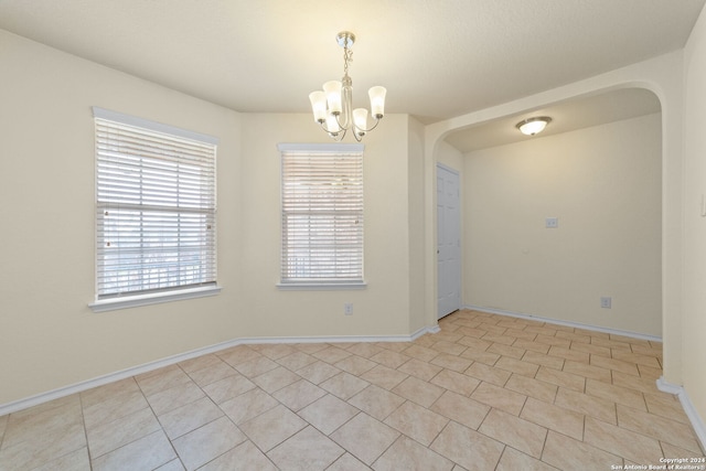 1407 Frio Eagle, San Antonio, TX 78245 - spare room featuring a chandelier, arched walkways, and baseboards