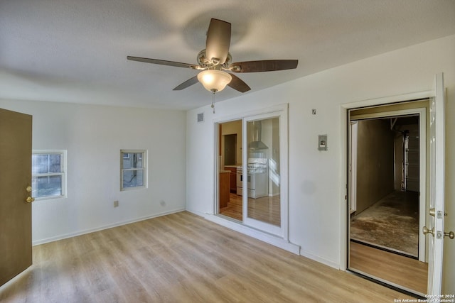 255 Gilbert Ln, San Antonio, TX 78213 - empty room featuring light wood-style floors, ceiling fan, baseboards, and a textured ceiling