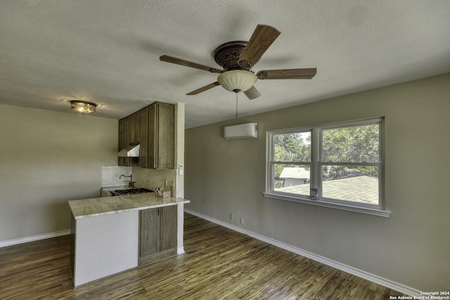 255 Gilbert Ln, San Antonio, TX 78213 - kitchen featuring a wall mounted air conditioner, baseboards, dark wood-type flooring, a ceiling fan, and a peninsula