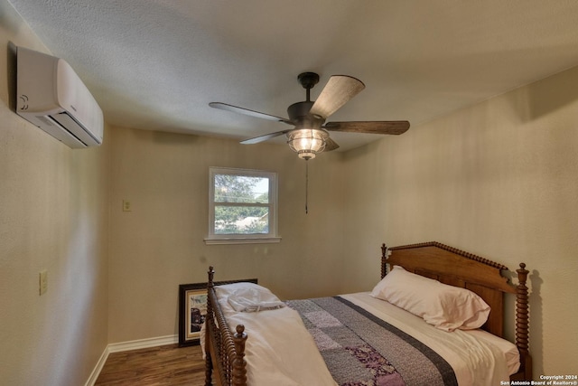 255 Gilbert Ln, San Antonio, TX 78213 - bedroom with an AC wall unit, dark wood-style flooring, baseboards, and a ceiling fan