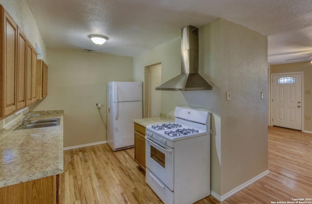 255 Gilbert Ln, San Antonio, TX 78213 - kitchen with white appliances, wall chimney exhaust hood, a sink, a textured ceiling, and light wood-style floors