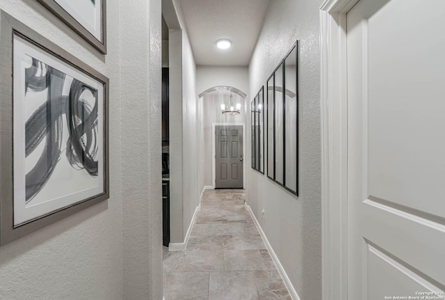 25725 Two Spgs, San Antonio, TX 78255 - hall featuring a textured wall, arched walkways, and baseboards